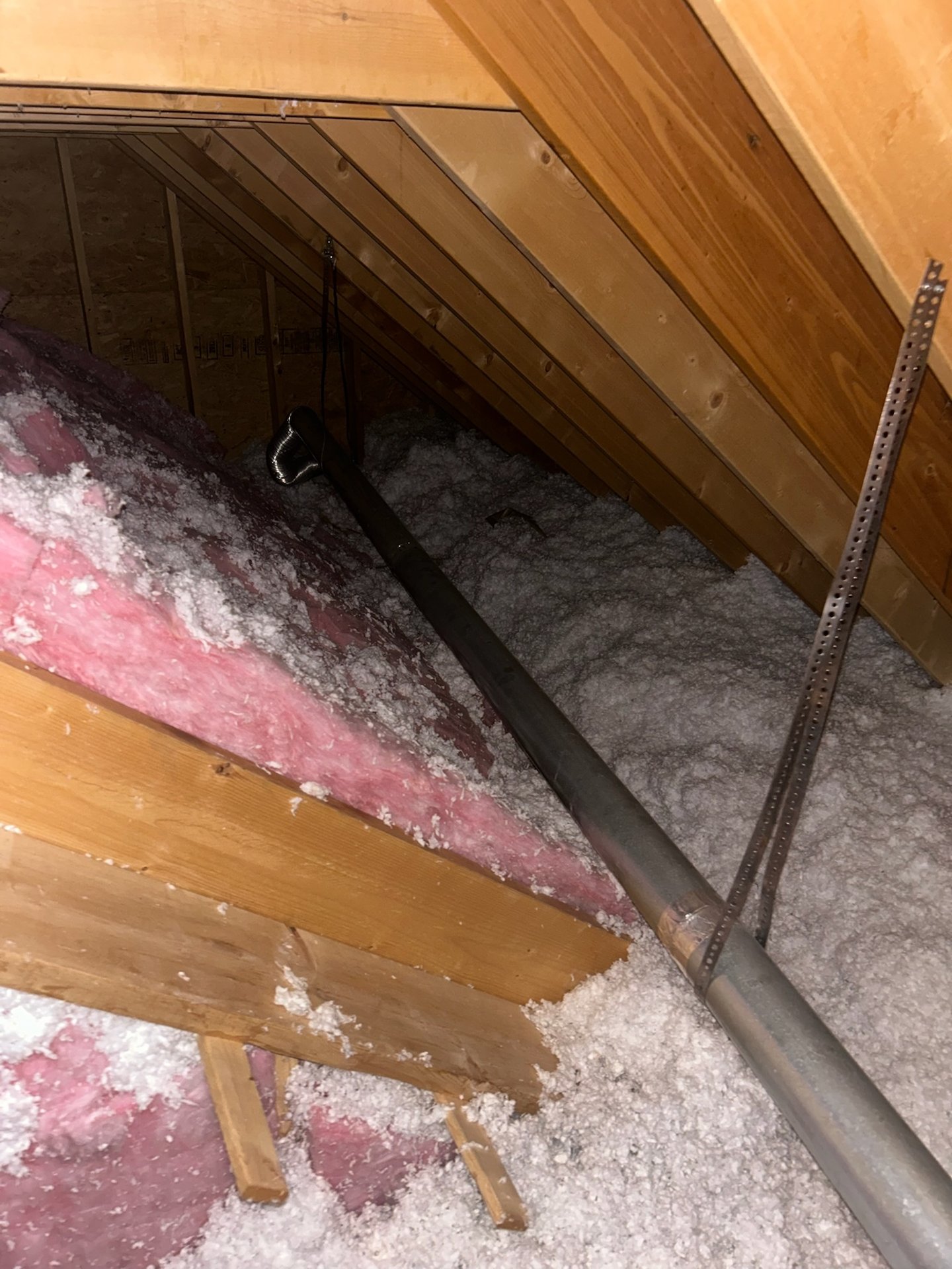 Dryer vent line running through attic insulation