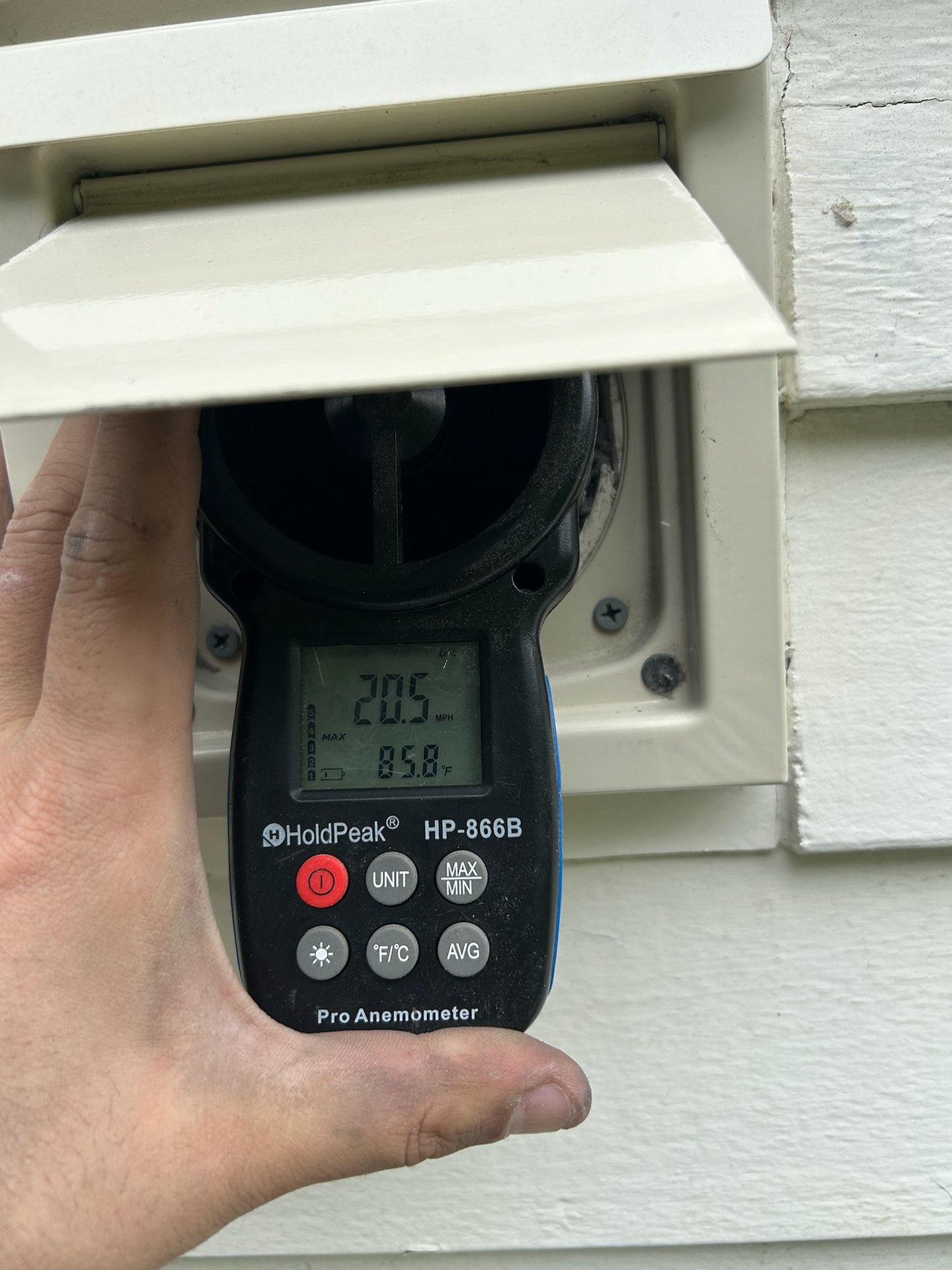 Anemometer reading airflow at a dryer vent